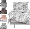 A collage of different bedding sets, with a large floral patterned bedding set prominently displayed on a bed frame. Produktbild-Vorschau