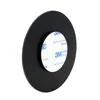 A close-up, angled view of a round, black cosmetic mirror with a 3M adhesive pad on the back. Produktbild-Vorschau