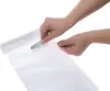 Hands are shown using a tool to cut a piece of plastic wrap from a roll. Produktbild-Vorschau