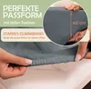 Close-up of a hand stretching a fitted sheet, with text overlays highlighting product features. Produktbild-Vorschau