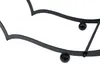 A close-up view of a black metal firewood rack with a heart shape. Produktbild-Vorschau