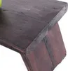 A close-up view of a dark brown wooden footstool. Produktbild-Vorschau