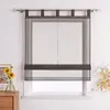 A dark gray sheer Roman shade with tabs hangs on a window, with a vase of sunflowers and a framed picture on a wooden dresser to the left. Produktbild-Vorschau