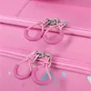 A close-up view of two zippers on a pink suitcase. Produktbild-Vorschau