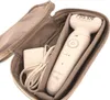 A white Braun Silk-épil 9 epilator and its charger are neatly placed inside a gray fabric case. Náhľad obrázku produktu