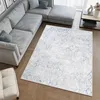A modern living room with a sectional sofa and a rug.
