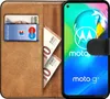 A book-style phone case is open, showing a phone and slots for cards and cash. Náhľad obrázku produktu