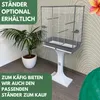 A bird cage on a stand, with a plant in the foreground and text overlays. Produktbild-Vorschau