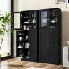 A black wooden cabinet with glass doors and shelves, filled with decorative items and books, is shown in a room with a large window and a plant. Podgląd zdjęcia produktu