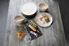 A table setting with plates, bowls, and food. Produktbild-Vorschau