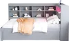 A gray daybed with a headboard featuring multiple shelves, displaying various decorative items and books. A white duvet and an orange throw blanket cover the mattress. The headboard has integrated LED lighting and a USB charging port. Produktbild-Vorschau