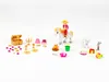A collection of small toy figures and accessories arranged on a white background. Produktbild-Vorschau