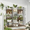 A display of two tall, narrow bookshelves filled with various plants and decorative items, set up on a wooden deck. Produktbild-Vorschau