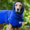 A golden retriever dog wearing a blue hooded robe outdoors. Produktbild-Vorschau