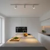 A modern, minimalist kitchen with white cabinets, integrated appliances, and a large island. Produktbild-Vorschau