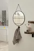 A bathroom scene with a mirror, towel, and shelves. Produktbild-Vorschau
