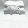 A white weighted blanket is folded on top of another white blanket, both on a white background. Podgląd zdjęcia produktu