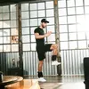 A man is exercising indoors with weights attached to his ankles. Náhľad obrázku produktu