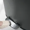 A close-up shot of a foot pressing the pedal of a trash can, with dimensions indicated. Anteprima dell’immagine prodotto
