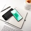 A smartphone with a green wallpaper is placed on an open notebook next to a black phone case and a pen. A coffee mug is visible in the background. Anteprima dell’immagine prodotto