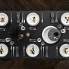 A beautifully set dining table with plates, cutlery, and decorative elements, suggesting a formal dining occasion. Náhľad obrázku produktu