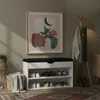 A hallway with a shoe cabinet, coat rack, and artwork. Produktbild-Vorschau