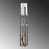 A tall, slender floor lamp with integrated shelving, displaying decorative items. Anteprima dell’immagine prodotto