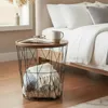 A bedside table with a basket and blankets next to a bed. Produktbild-Vorschau
