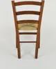 The back view of a wooden chair with a straw seat. Produktbild-Vorschau