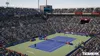 A tennis stadium filled with spectators watching a match. Produktbild-Vorschau