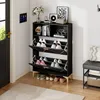 A black shoe cabinet with gold legs is shown in an entryway next to a door and a bench. Podgląd zdjęcia produktu