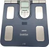 A top-down view of a blue Omron Karada Scan body composition monitor on a white background. Podgląd zdjęcia produktu