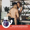 A couple embracing in a kitchen setting, with a product bottle in the foreground. Produktbild-Vorschau