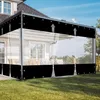 A transparent outdoor curtain is installed on a patio or balcony, attached to a house. Produktbild-Vorschau