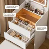 Close-up view of makeup organizer drawers and compartments, showing various cosmetic products. Náhľad obrázku produktu