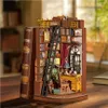 A miniature diorama of a study room inside an open book, displayed on a wooden surface. Náhled obrázku produktu
