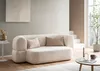 A modern living room with a cream-colored sofa, side table, and coffee table. Produktbild-Vorschau