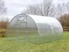 A greenhouse with a transparent roof and walls, set up in a grassy outdoor area with trees in the background. Voir les images du produit
