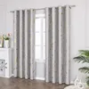 A pair of grey curtains with a gold marble pattern hanging in front of a window. Produktbild-Vorschau