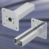 Two metal fence post brackets are shown against a blurred background. Produktbild-Vorschau
