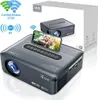 A projector is shown with a smartphone displaying a family photo on its screen, placed on top of the projector. A box with product information is in the background. Voir les images du produit