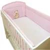 A baby crib with pink bedding and a teddy bear motif. Produktbild-Vorschau