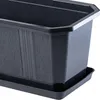 A close-up view of a black planter with a textured surface and a matching saucer, isolated on a white background. Podgląd zdjęcia produktu