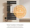 A black electric towel warmer with a towel hanging on it, with a circular overlay highlighting a timer function. Produktbild-Vorschau