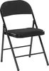 A plain white background with a black folding chair. Náhľad obrázku produktu