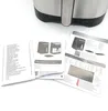 An air fryer and accompanying instruction manuals laid out on a white surface. Voir les images du produit