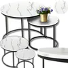 A set of nesting coffee tables with a marble-like pattern and gold accents, along with a small vase of flowers. Produktbild-Vorschau