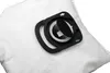A close-up shot of a white vacuum cleaner bag with a black plastic fitting. Náhľad obrázku produktu