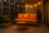 A balcony at dusk with a sofa, coffee table, and plants, illuminated by string lights. Anteprima dell’immagine prodotto