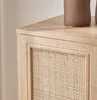 A close-up shot of a wooden cabinet with a rattan insert. Anteprima dell’immagine prodotto